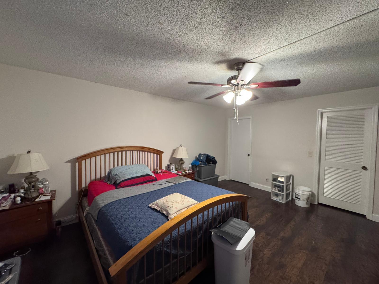 22715 Southwest 66th Avenue, Unit 105 Boca Raton, FL 33428 - Photo 6 of 13 a bed room with a bed and a chandelier