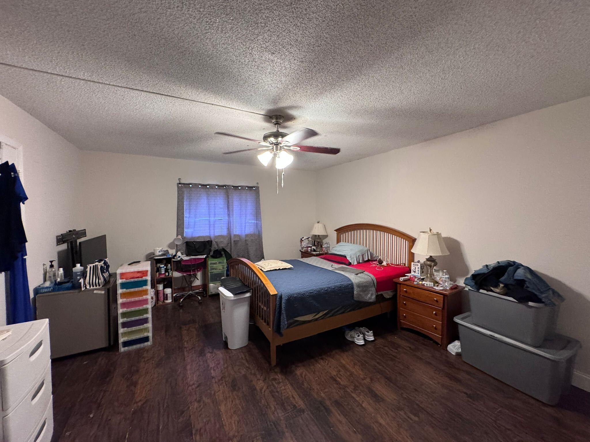 22715 Southwest 66th Avenue, Unit 105 Boca Raton, FL 33428 - Photo 7 of 13 a bedroom with bed and a chandelier