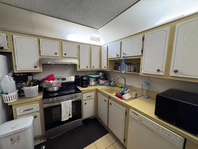 a kitchen with a sink appliances and cabinets