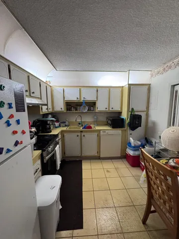a kitchen with stainless steel appliances a refrigerator sink and cabinets