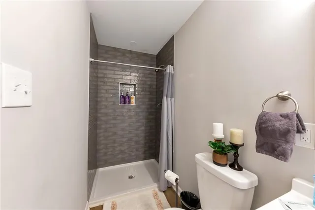 a bathroom with a toilet and a shower