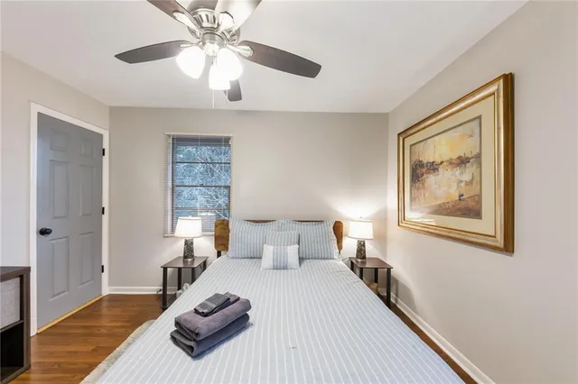 a bedroom with a large bed and a chandelier