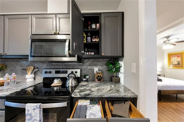 a kitchen with a stove and a microwave