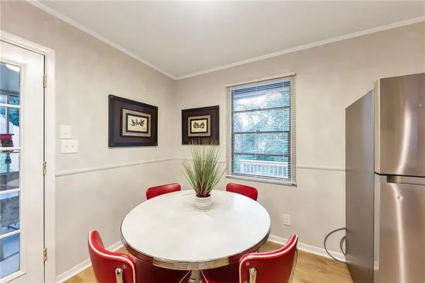 a view of a dining room with furniture window and wooden floor