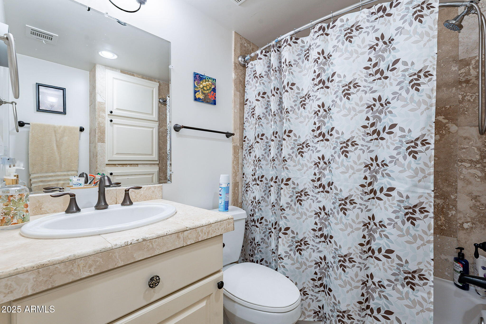 15606 South Gilbert Road, Unit 63 Chandler, AZ 85225 - Photo 20 of 21 a bathroom with a granite countertop toilet sink mirror and shower