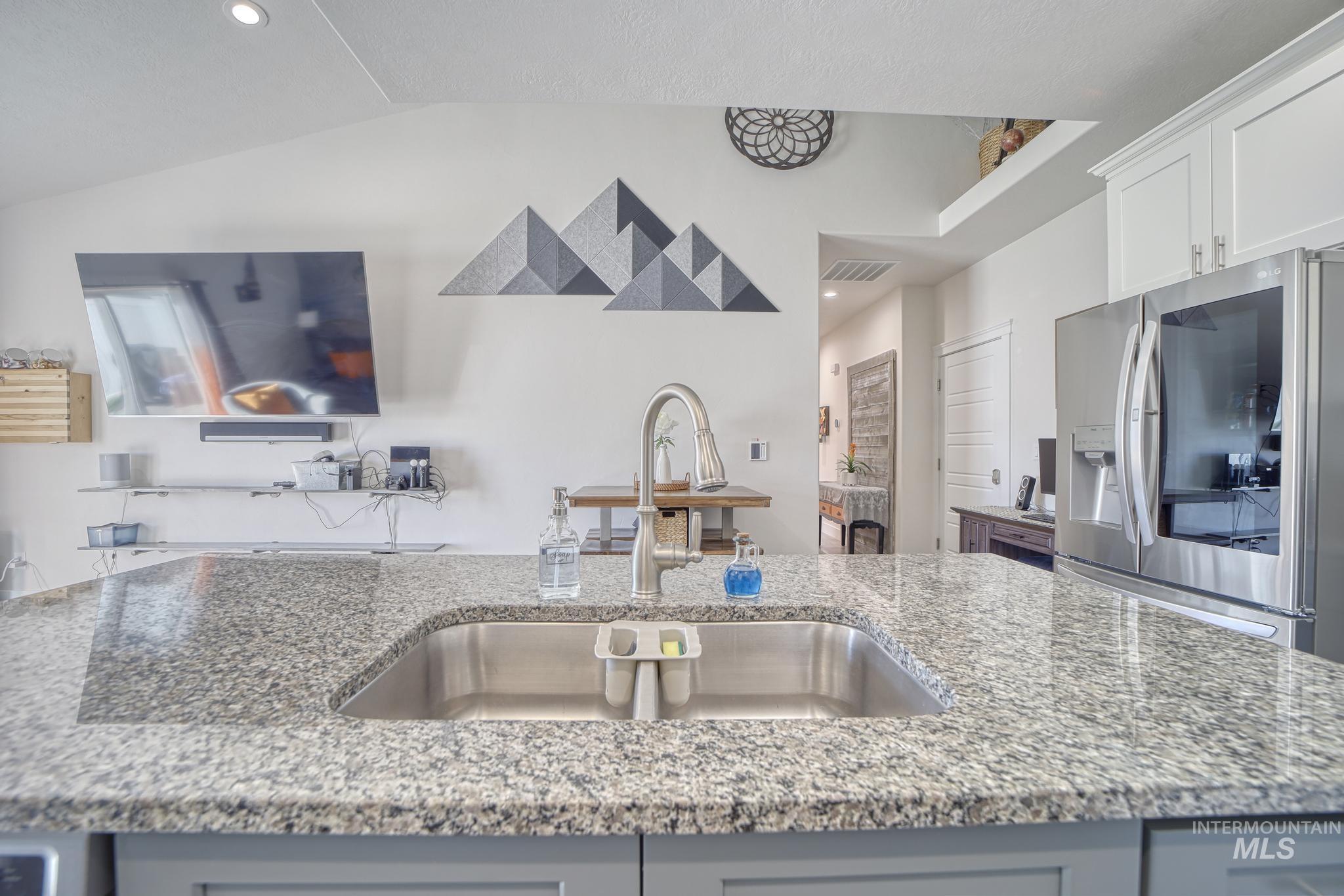 1087 Easy Avenue Twin Falls, ID 83301 - Photo 9 of 25 Kitchen with stainless steel fridge, light stone countertops, gray cabinets, recessed lighting, and an island with sink
