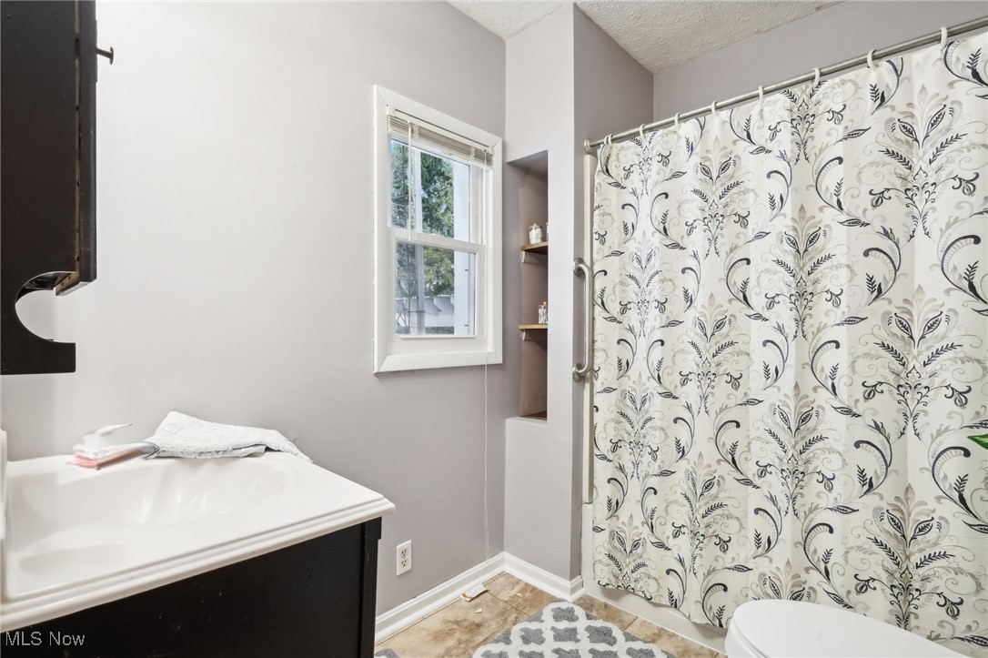22120 Center Road Alliance, OH 44601 - Photo 10 of 41 Full bath with vanity, a textured ceiling, and a shower with curtain