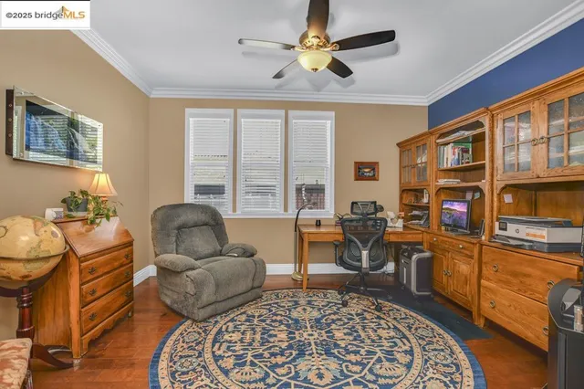 a living room with furniture a rug and a window