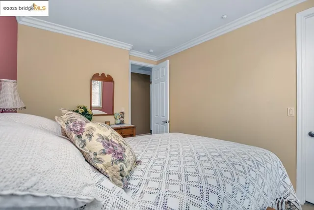 a bedroom with a large bed and a dresser