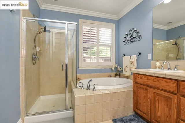 a bathroom with a granite countertop tub sink shower and mirror