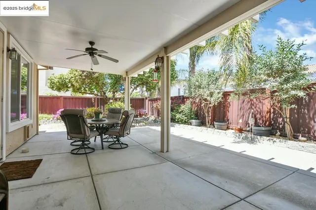 a view of a patio with a table and chairs