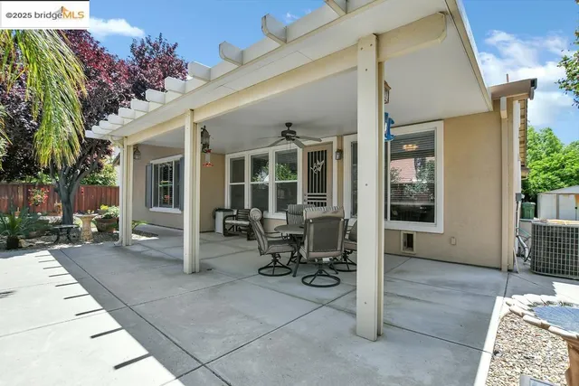 a view of a patio with table and chairs and potted plants