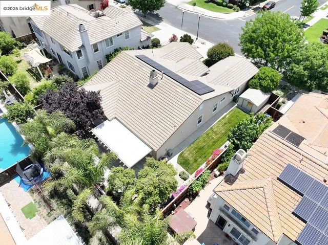 an aerial view of multiple houses with yard