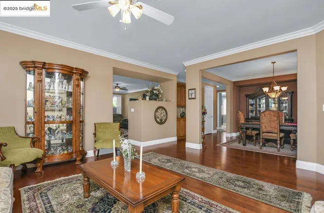 a living room with fireplace furniture and a chandelier