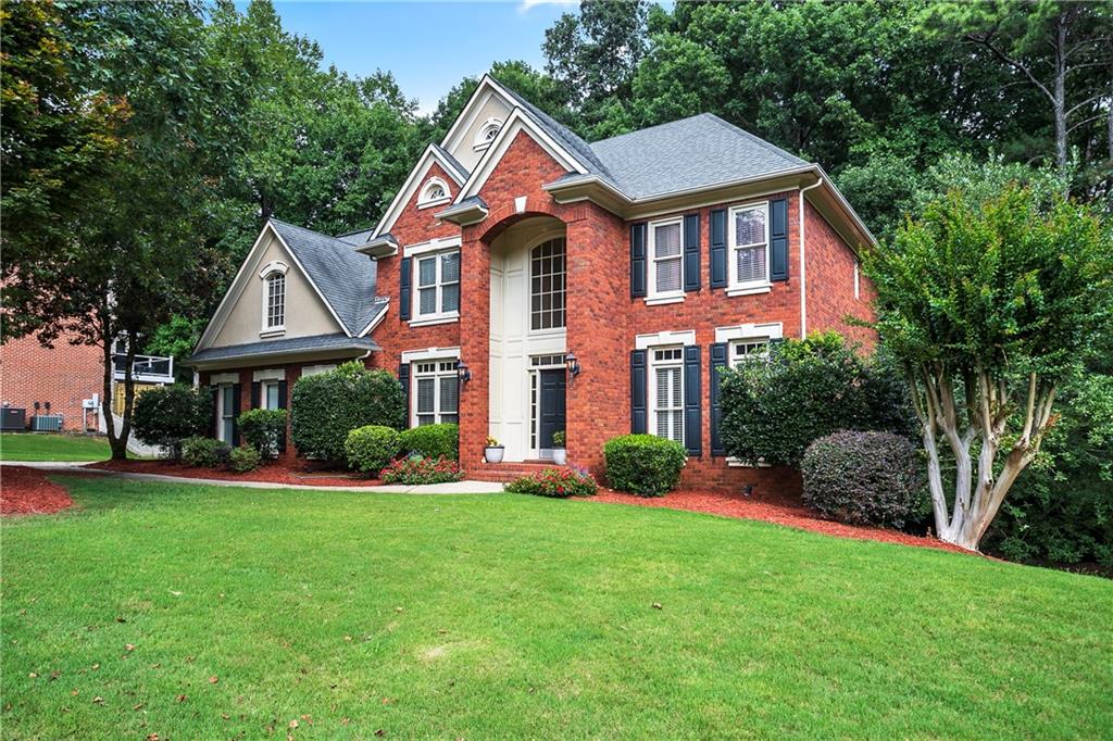 669 Crescent Ridge Trail Smyrna, GA 30126 - Photo 1 of 1 a front view of a house with a yard and trees