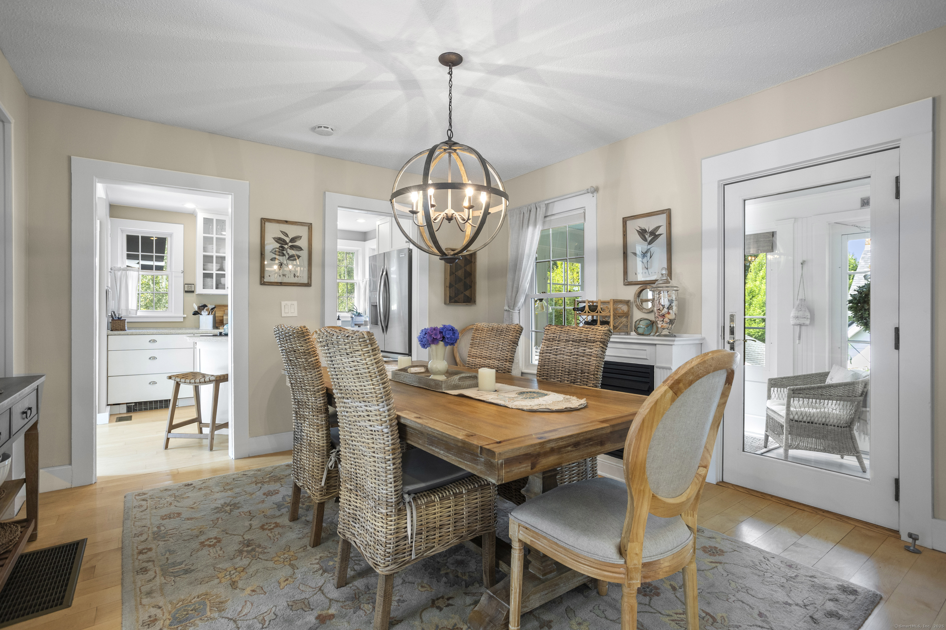 22 School Street Stonington, CT 06355 - Photo 12 of 39 a view of a dining room with furniture a chandelier and wooden floor