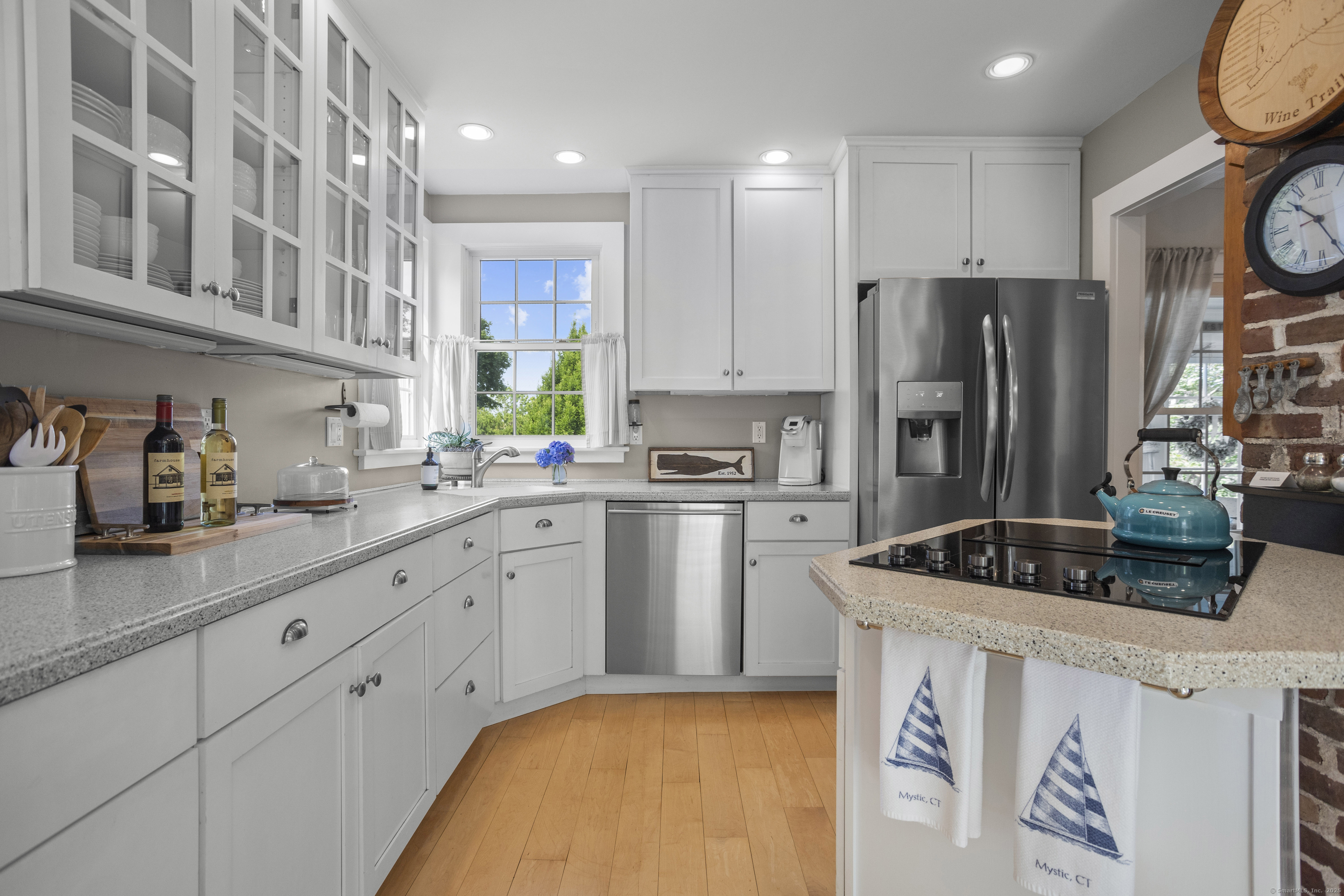 22 School Street Stonington, CT 06355 - Photo 16 of 39 a kitchen with a sink a refrigerator and cabinets