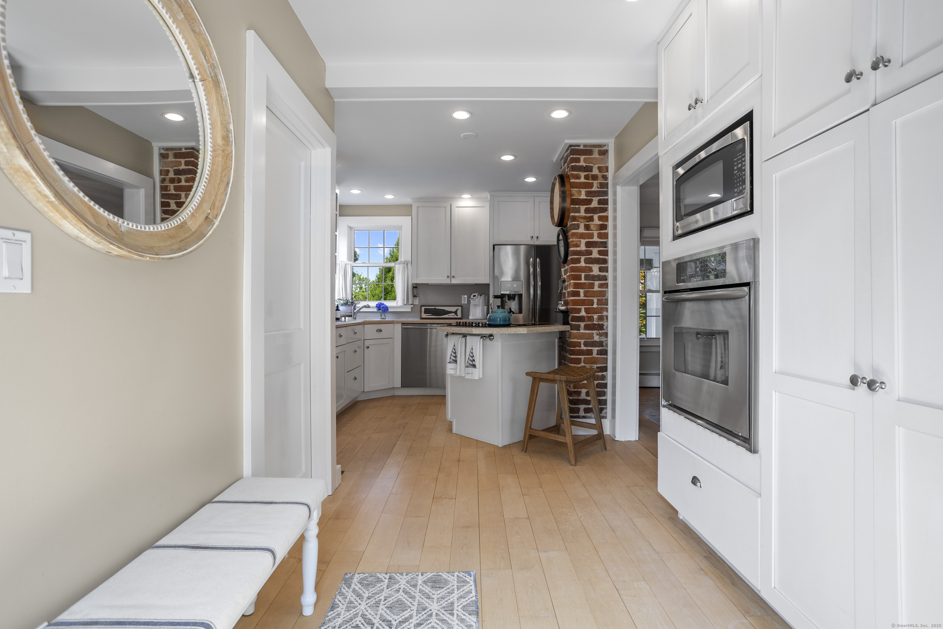 22 School Street Stonington, CT 06355 - Photo 17 of 39 a kitchen with granite countertop a refrigerator a sink a stove and cabinets