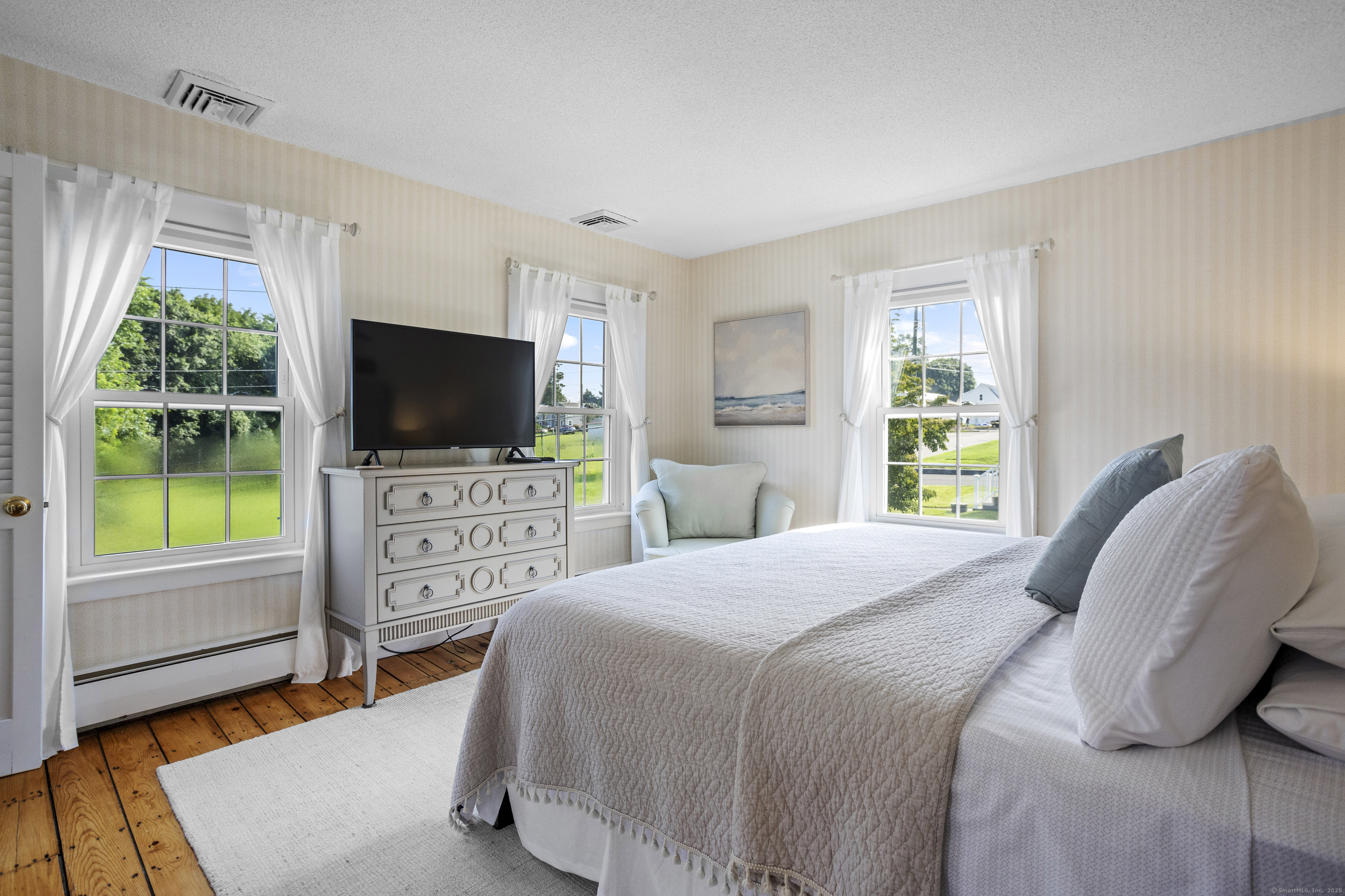 22 School Street Stonington, CT 06355 - Photo 21 of 39 a bedroom with a flat screen television and a bed