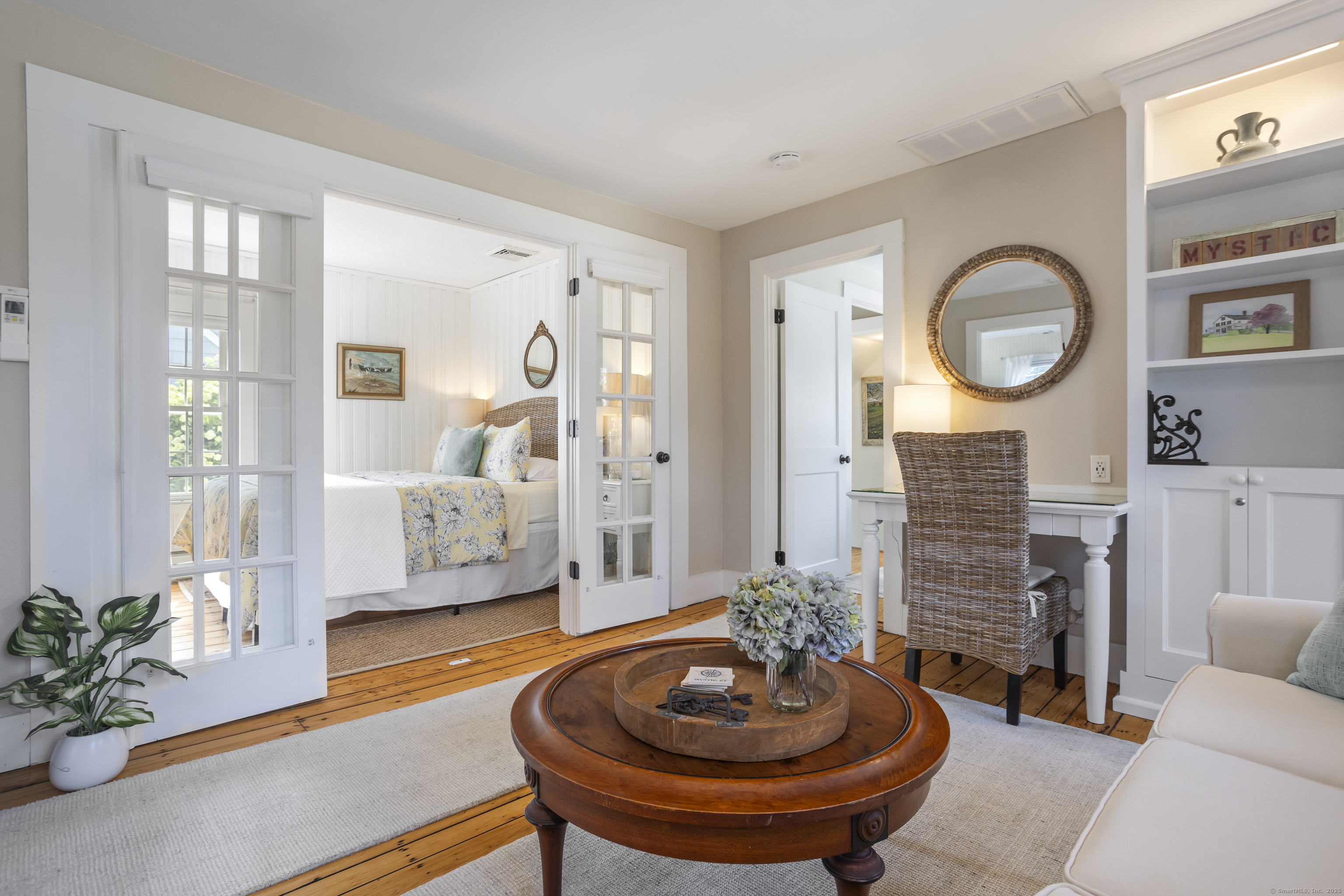 22 School Street Stonington, CT 06355 - Photo 27 of 39 a living room with patio furniture and a fireplace
