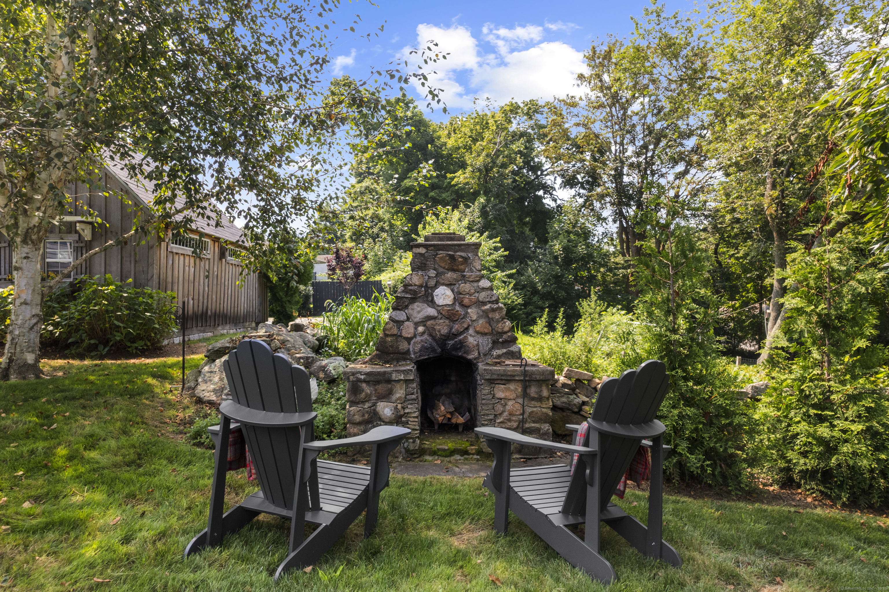 22 School Street Stonington, CT 06355 - Photo 39 of 39 a view of a chairs and table in a back yard of the house