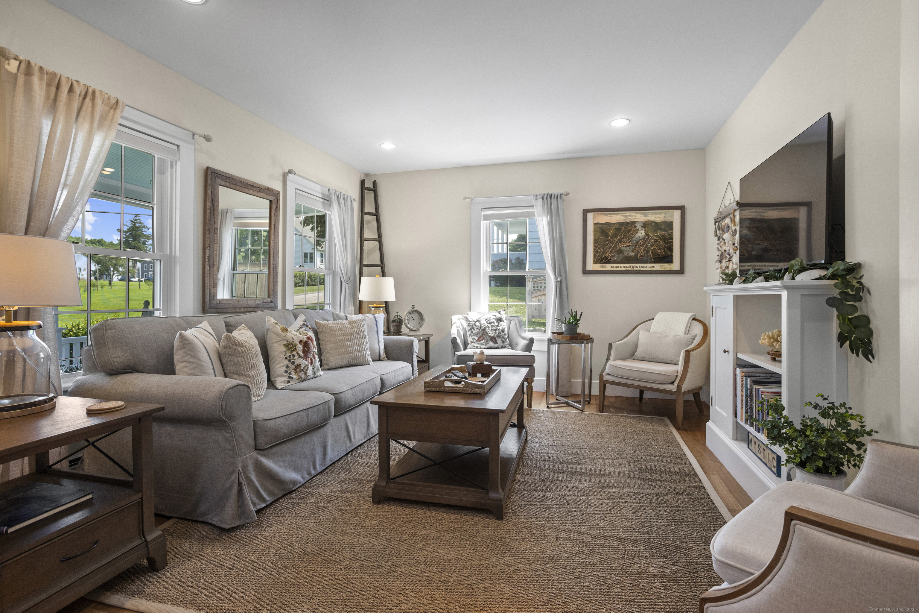 22 School Street Stonington, CT 06355 - Photo 7 of 39 a living room with furniture flat screen tv and a large window