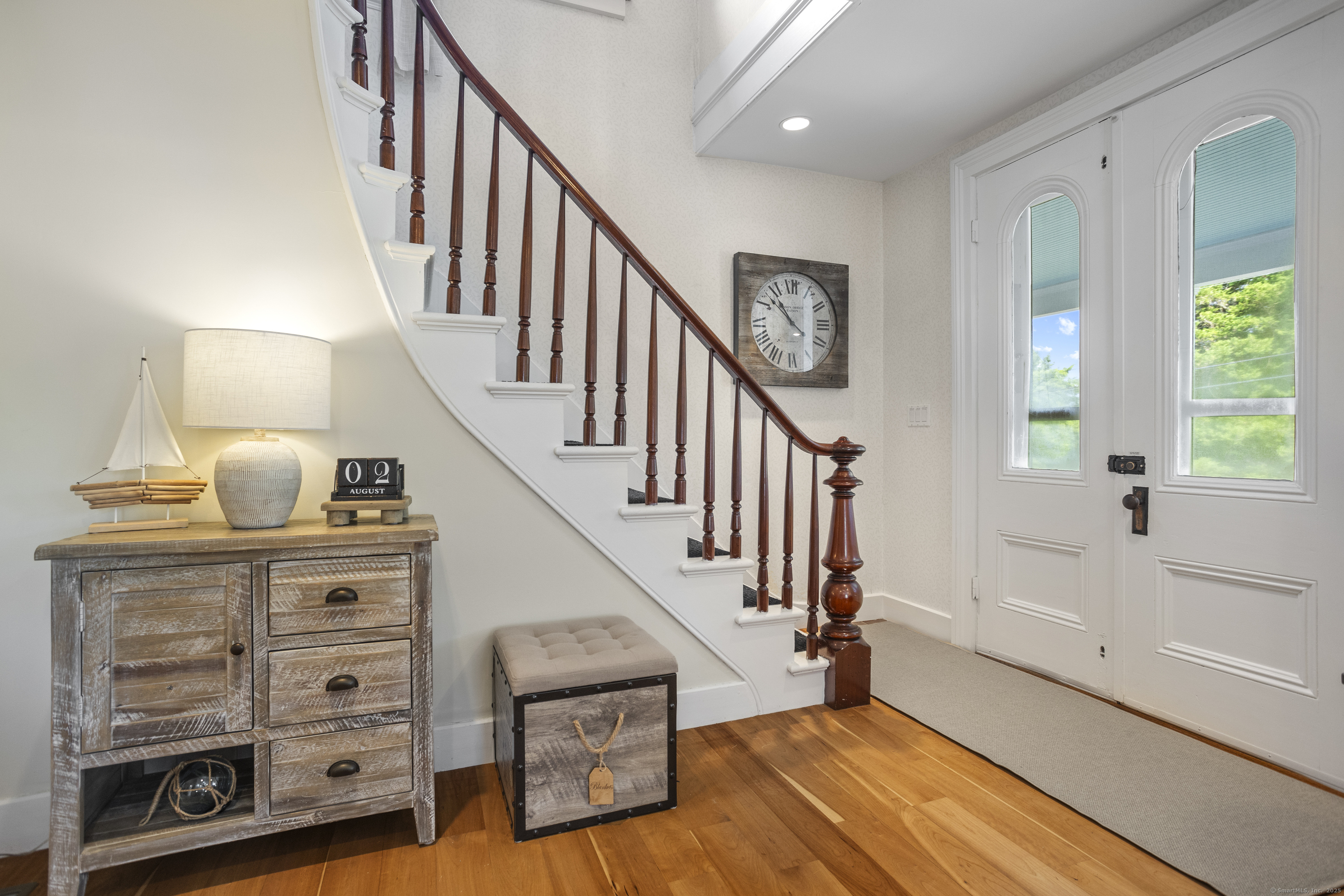 22 School Street Stonington, CT 06355 - Photo 9 of 39 a view of hallway with wooden floor and stairs