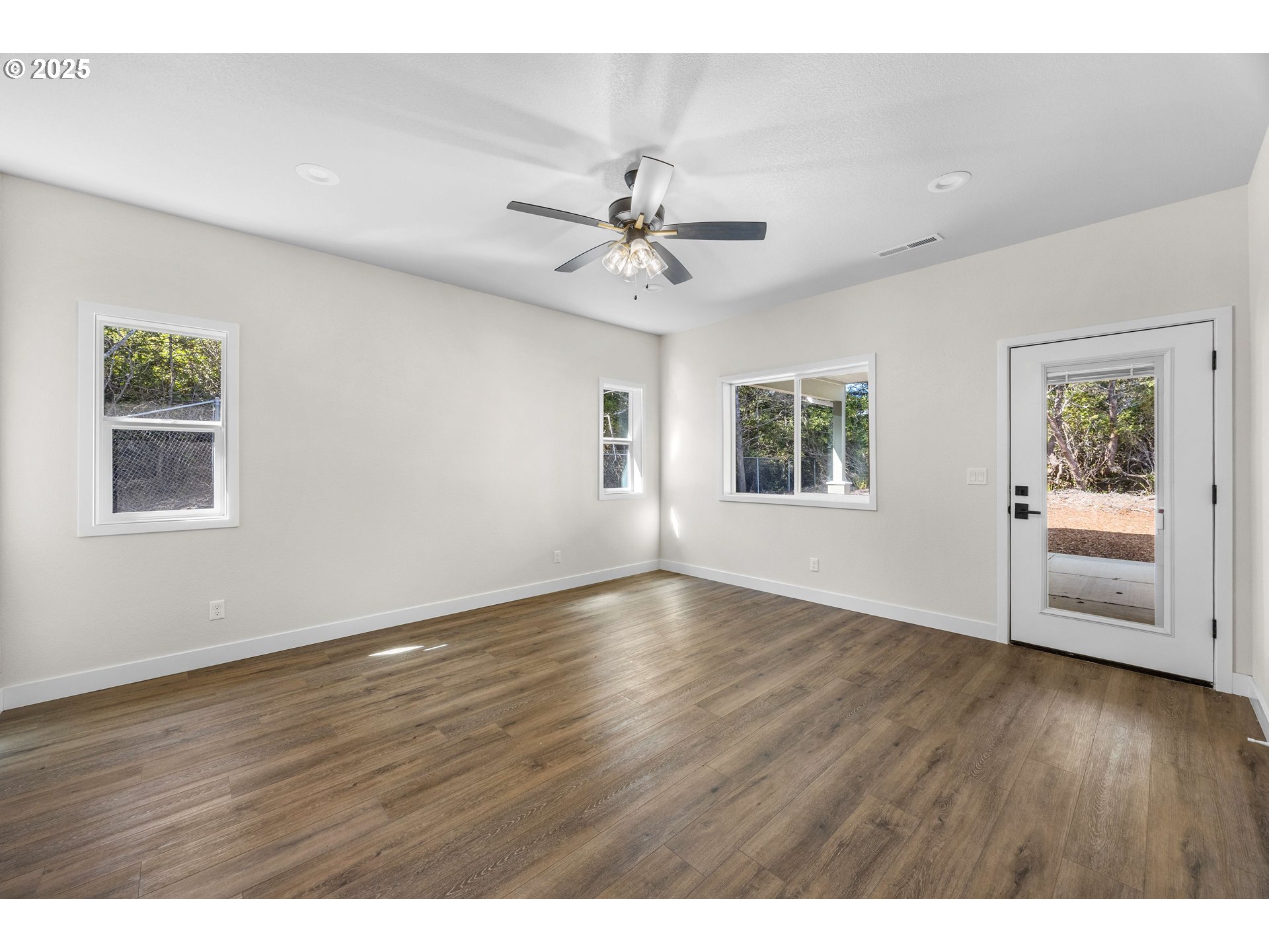 1 Bonnett Way Florence, OR 97439 - Photo 12 of 33 a view of an empty room with window and wooden floor