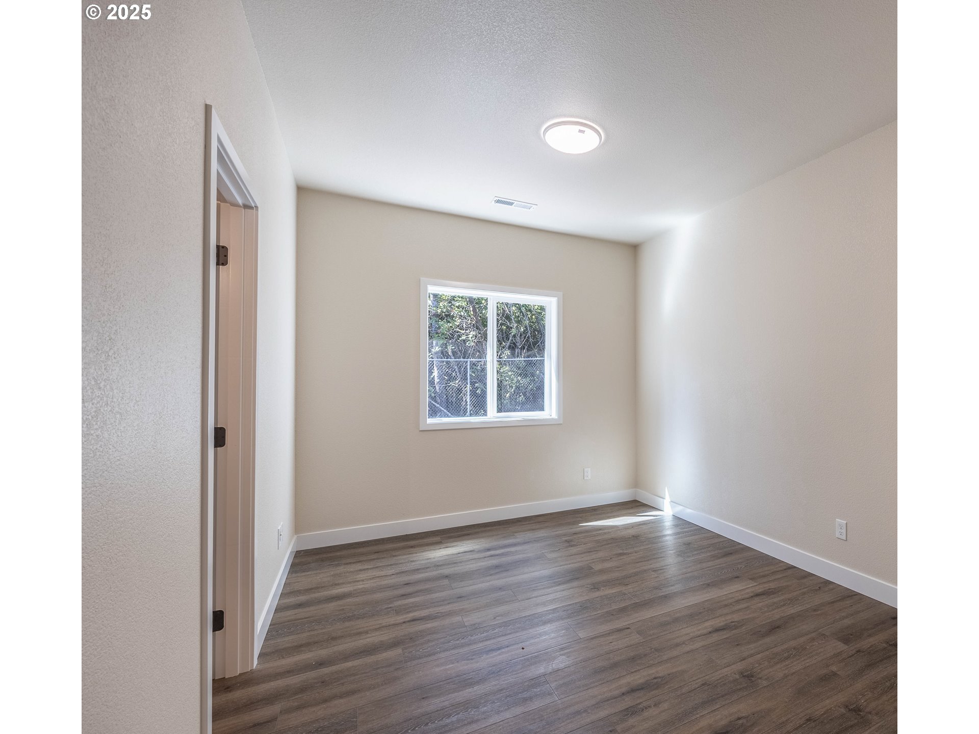 1 Bonnett Way Florence, OR 97439 - Photo 21 of 33 a view of an empty room with wooden floor and a window