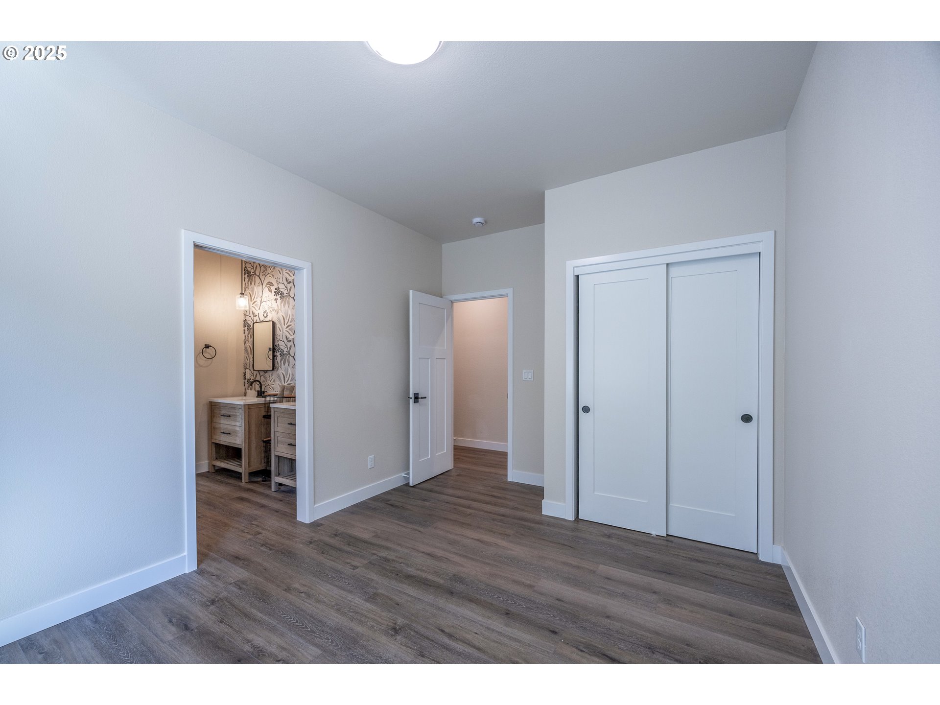 1 Bonnett Way Florence, OR 97439 - Photo 23 of 33 a view of an empty room with wooden floor