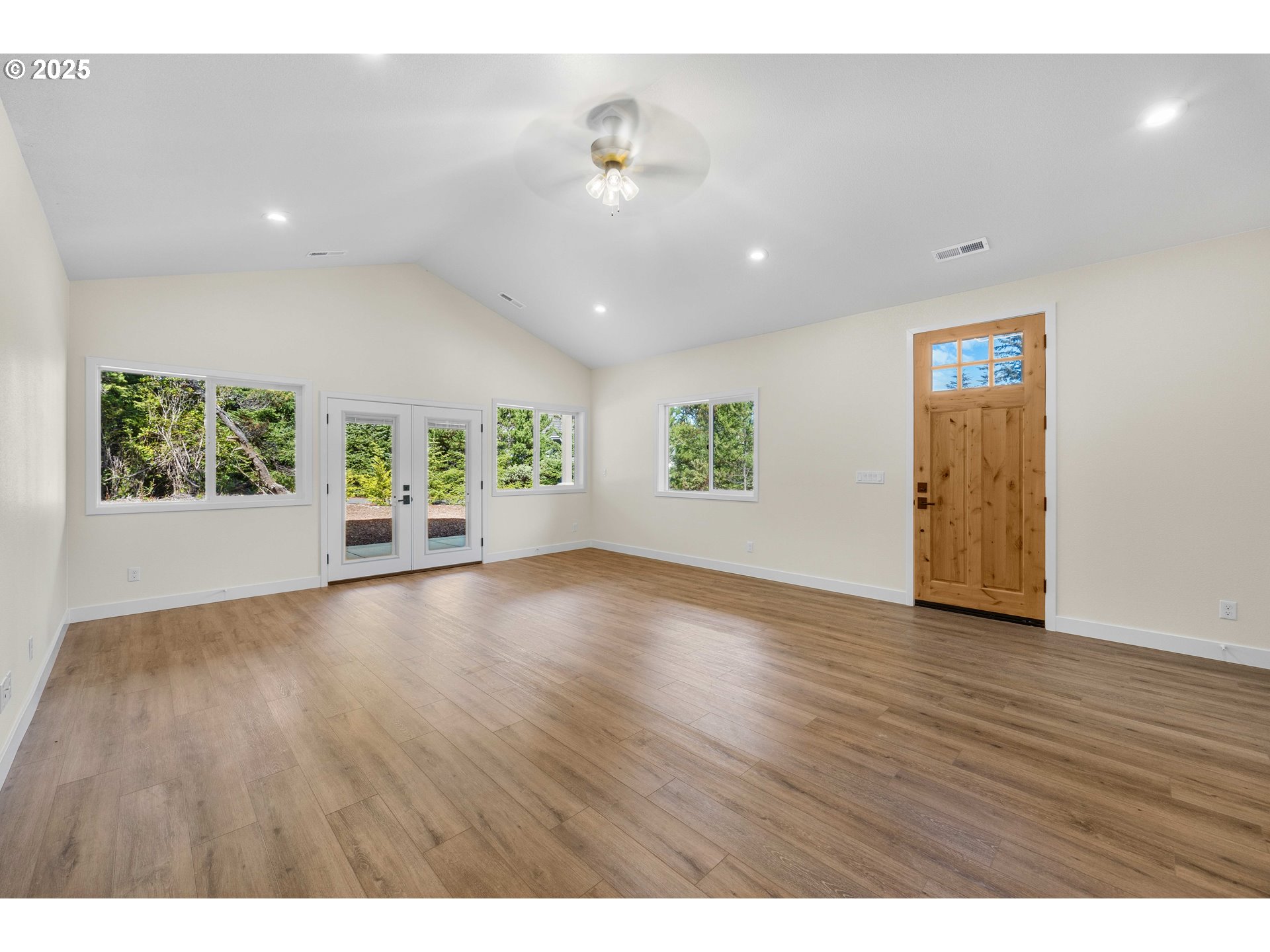 1 Bonnett Way Florence, OR 97439 - Photo 3 of 33 a view of an empty room with a window and wooden floor