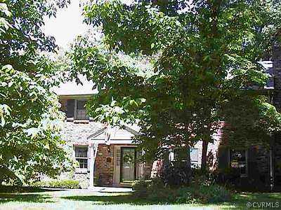 13005 Birchleaf Road Chester, VA 23831 - Photo 1 of 1 a front view of a house with a garden and trees