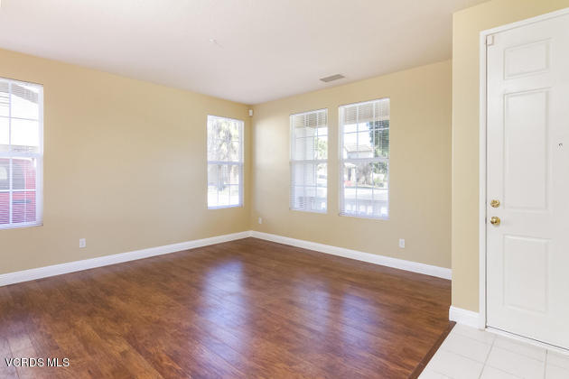 2001 Ribera Drive Oxnard, CA 93030 - Photo 3 of 20 a view of an empty room with wooden floor and a window