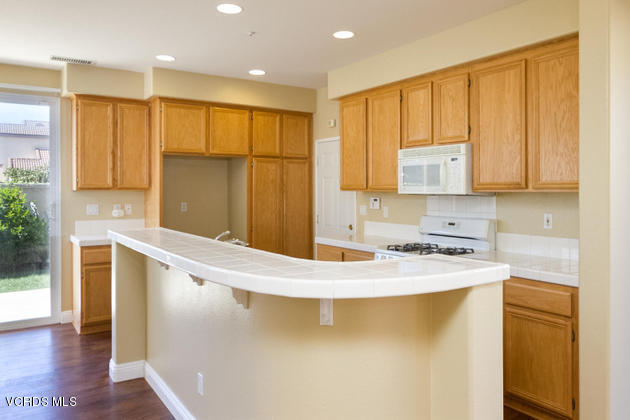 2001 Ribera Drive Oxnard, CA 93030 - Photo 6 of 20 a kitchen with a sink a stove and cabinets
