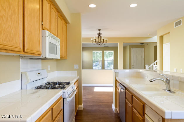 2001 Ribera Drive Oxnard, CA 93030 - Photo 7 of 20 a kitchen with stainless steel appliances granite countertop a sink stove and cabinets