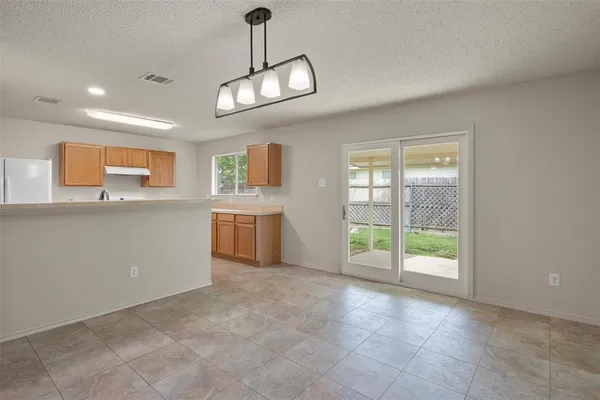 a view of a kitchen with a sink and dishwasher cabinets