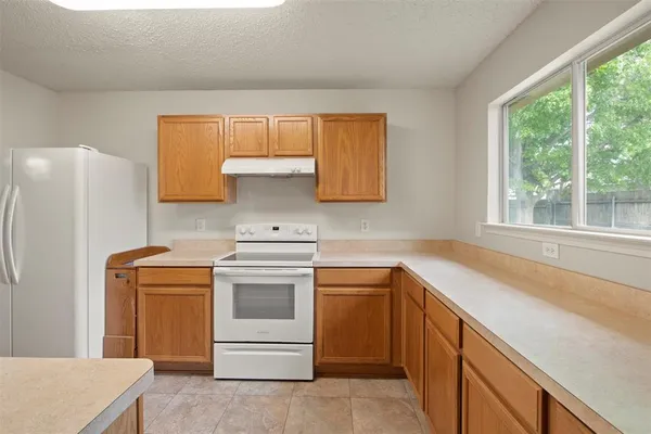 a kitchen with a sink stove and refrigerator