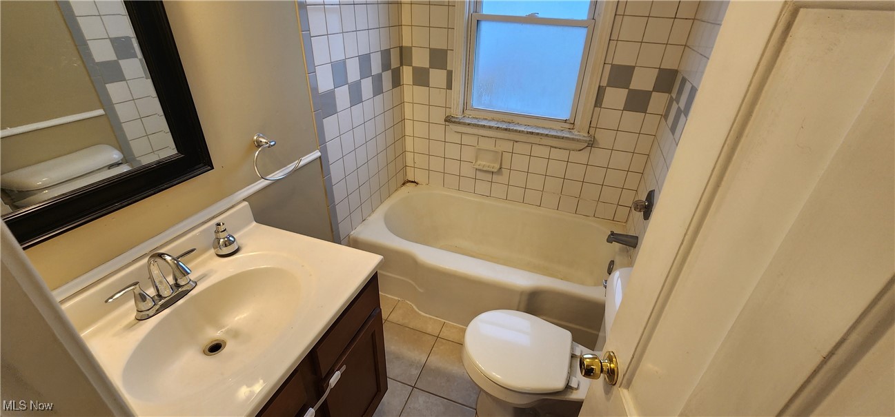 4161 Lambert Road Cleveland, OH 44121 - Photo 8 of 18 Full bathroom with tile patterned flooring, vanity, toilet, and tiled shower / bath