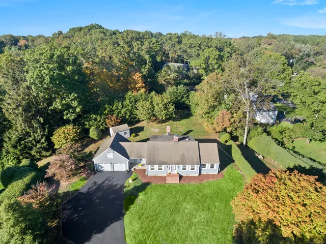 an aerial view of a house with a yard