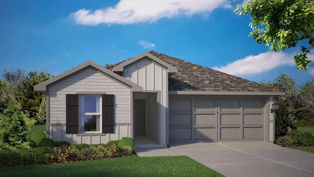 a front view of a house with a garden and yard