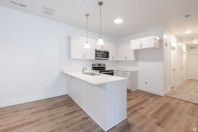 4664 South 680th West, Unit S303 Mapleton, UT 84664 - Photo 14 of 18 Modern kitchen featuring white cabinetry, stainless steel appliances, and sleek countertops
