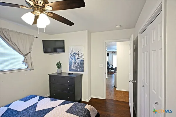 a bedroom with a bed and a flat screen tv