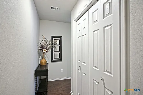 wooden floor with windows and closet