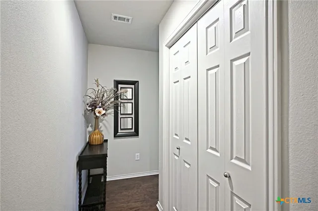 wooden floor with windows and closet