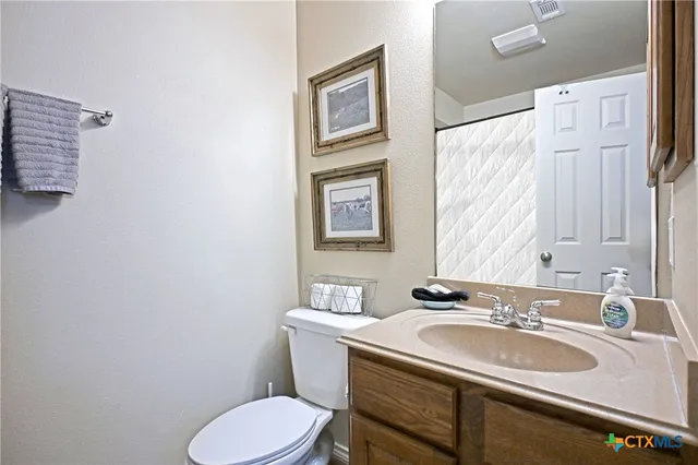 a bathroom with a sink toilet and a mirror