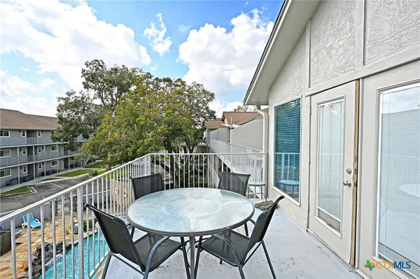 a view of balcony with furniture