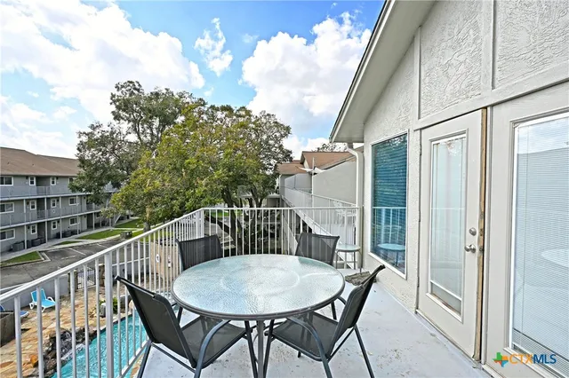a view of balcony with furniture