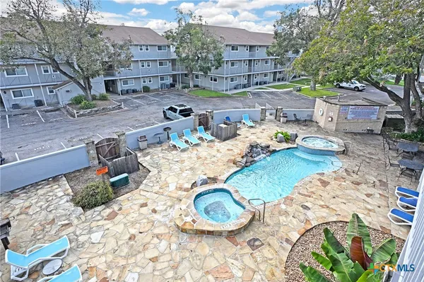a table and chairs in a backyard space