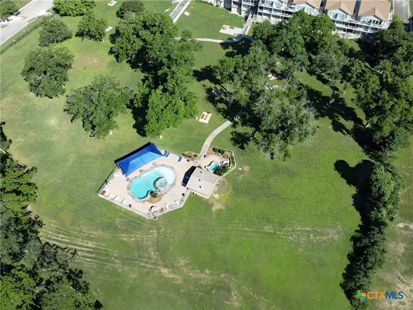 an aerial view of a house with yard swimming pool and outdoor seating