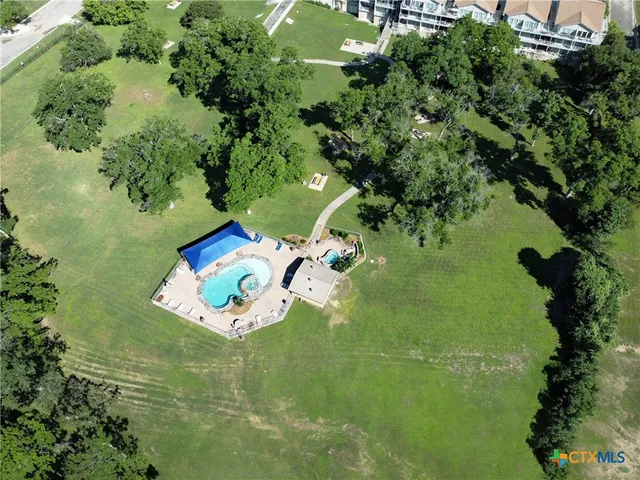 an aerial view of a house with yard swimming pool and outdoor seating